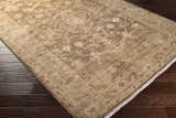 Close-up of the Lochmaben Premium Wool Rug showing its traditional floral pattern and neutral colors on dark wood flooring. Corner