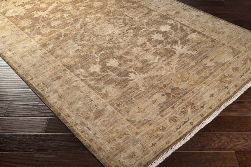 Close-up of the Lochmaben Premium Wool Rug showing its traditional floral pattern and neutral colors on dark wood flooring. Corner