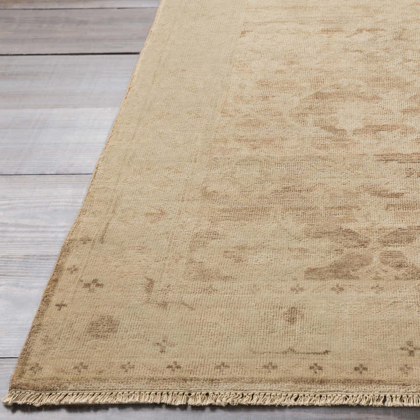 Close-up of the tan Lochmaben Premium Wool Rug showing its traditional pattern and hand-knotted texture. Front