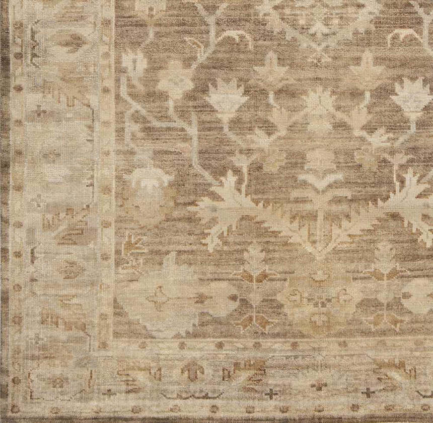 Close up of the Lochmaben Premium Wool Rug showing its traditional floral pattern in shades of tan, light brown, and ivory. Swatch