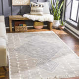 Living room scene with charcoal wall, wood bench, and Lodwar Area Rug in cream, gray, and charcoal. Roomscene-Rectangle
