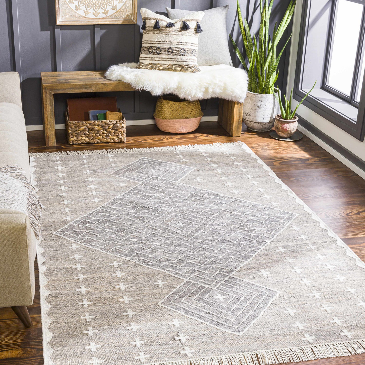 Living room scene with charcoal wall, wood bench, and Lodwar Area Rug in cream, gray, and charcoal. Roomscene-Rectangle