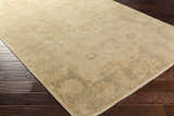Close-up of the hand-knotted Longisland Clearance Rug. The rug is ice blue, light beige, and wheat, with a traditional pattern. Corner