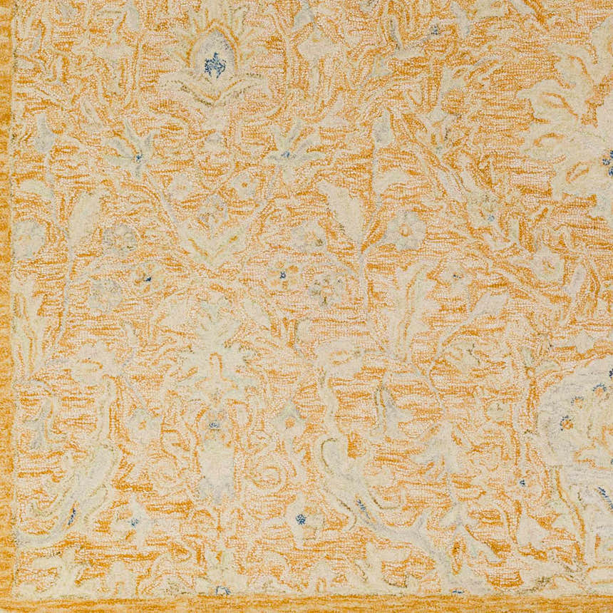 Close-up of the hand-tufted Lonoy 2x3 wool rug. Features coral, cream, and blue floral pattern. Bohemian style. Swatch