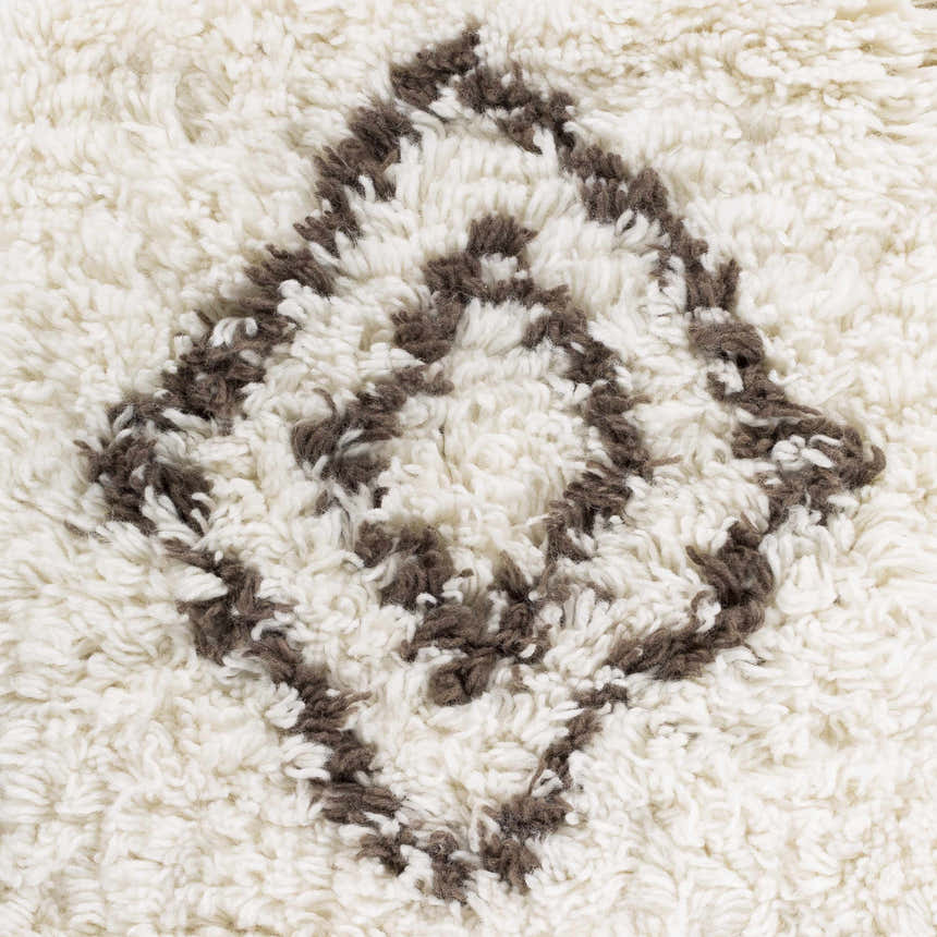 Close-up of the shag Lothian Area Rug. Ivory wool with a charcoal diamond pattern. Hand woven texture. Swatch