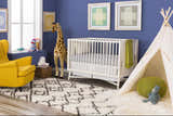 Nursery with blue walls, yellow chair, and Lothian rug in charcoal and ivory. Modern bohemian style. Roomscene-Rectangle