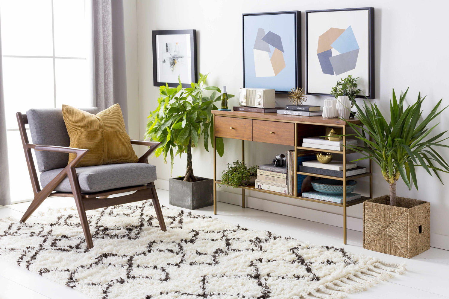 Living room scene with charcoal and ivory Lothian Area Rug, mid-century chair, console table, and plants. Bohemian style. Roomscene-Rectangle