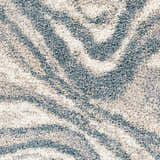 Close-up of the Lottery Area Rug showing a blue and cream abstract shag pattern. Swatch