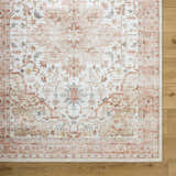 Close-up of the Lotan Pink Medallion Washable Area Rug showing its traditional light gray, tan, and sterling gray pattern. Corner