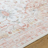 Close-up of the Lotan Pink Medallion Washable Area Rug. Features light gray, sterling gray, and tan colors. Texture