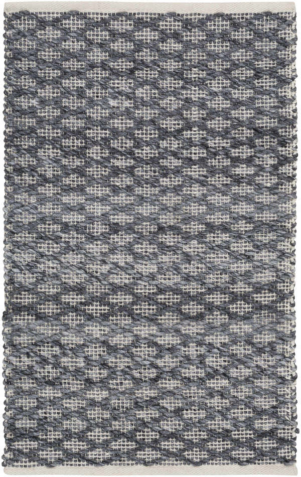 Close-up of the Alta Area Rug. Hand-woven polyester rug in charcoal, cream, and light gray with a geometric pattern. Design-Rectangle-23