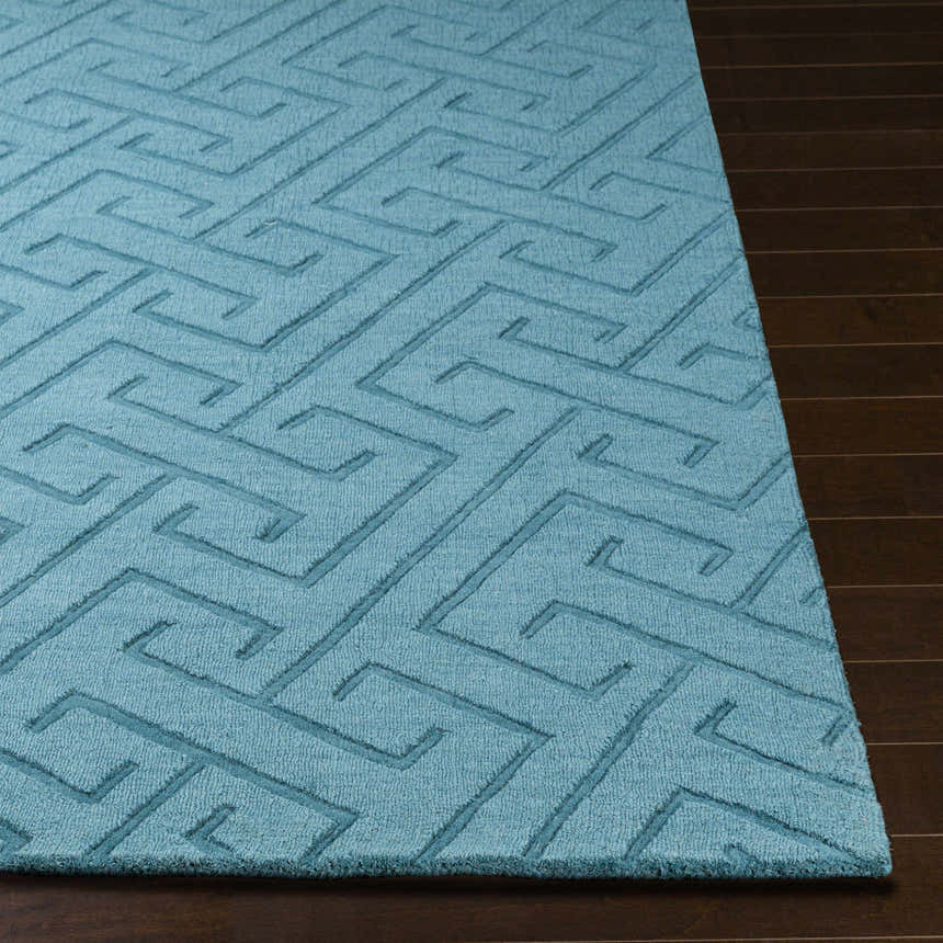 Close-up of the teal Ludden Area Rug showing the contemporary geometric pattern and hand-loomed wool texture. Front