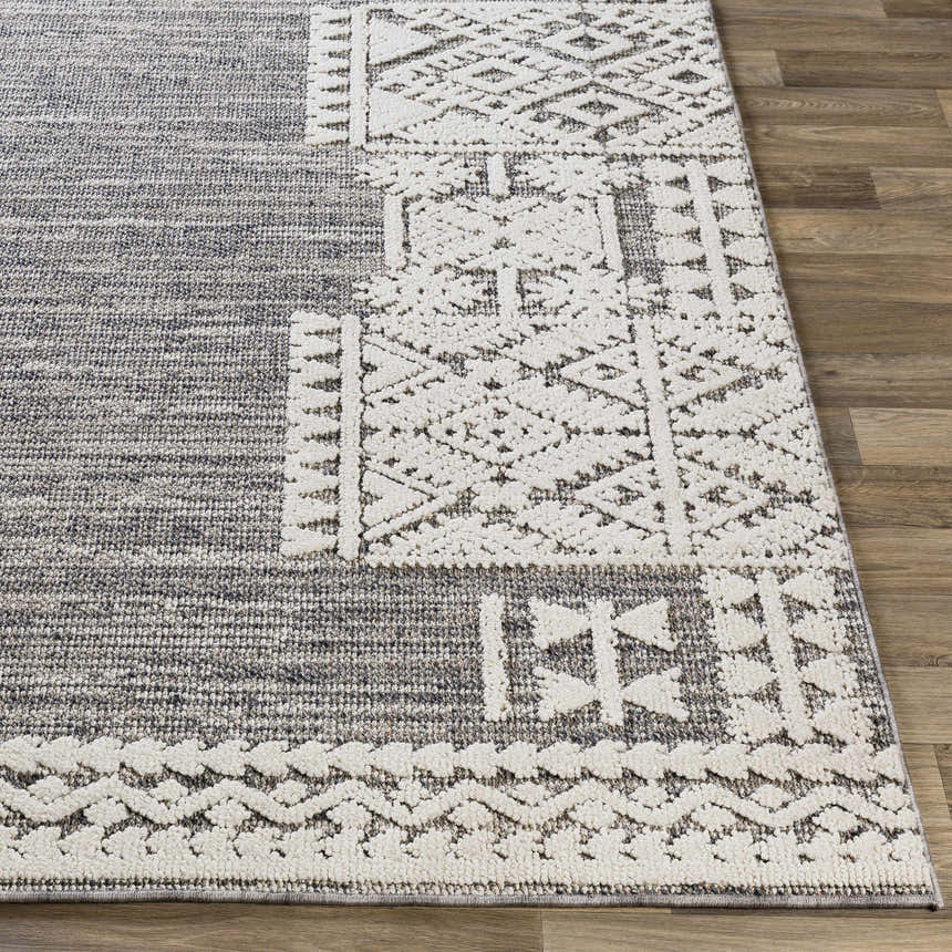 Close up of the Luddenham textured outdoor rug. Gray rug with white geometric farmhouse pattern. Front