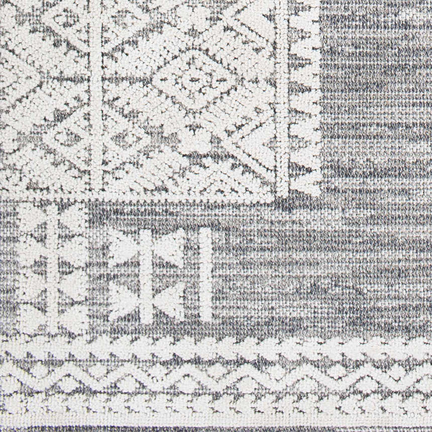 Close-up of the Luddenham Textured Outdoor Rug. Gray rug with white geometric farmhouse design. Swatch