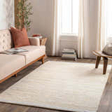 Living room scene with a light beige Lumatil Area Rug, sofa, and wood accents. Roomscene-Rectangle