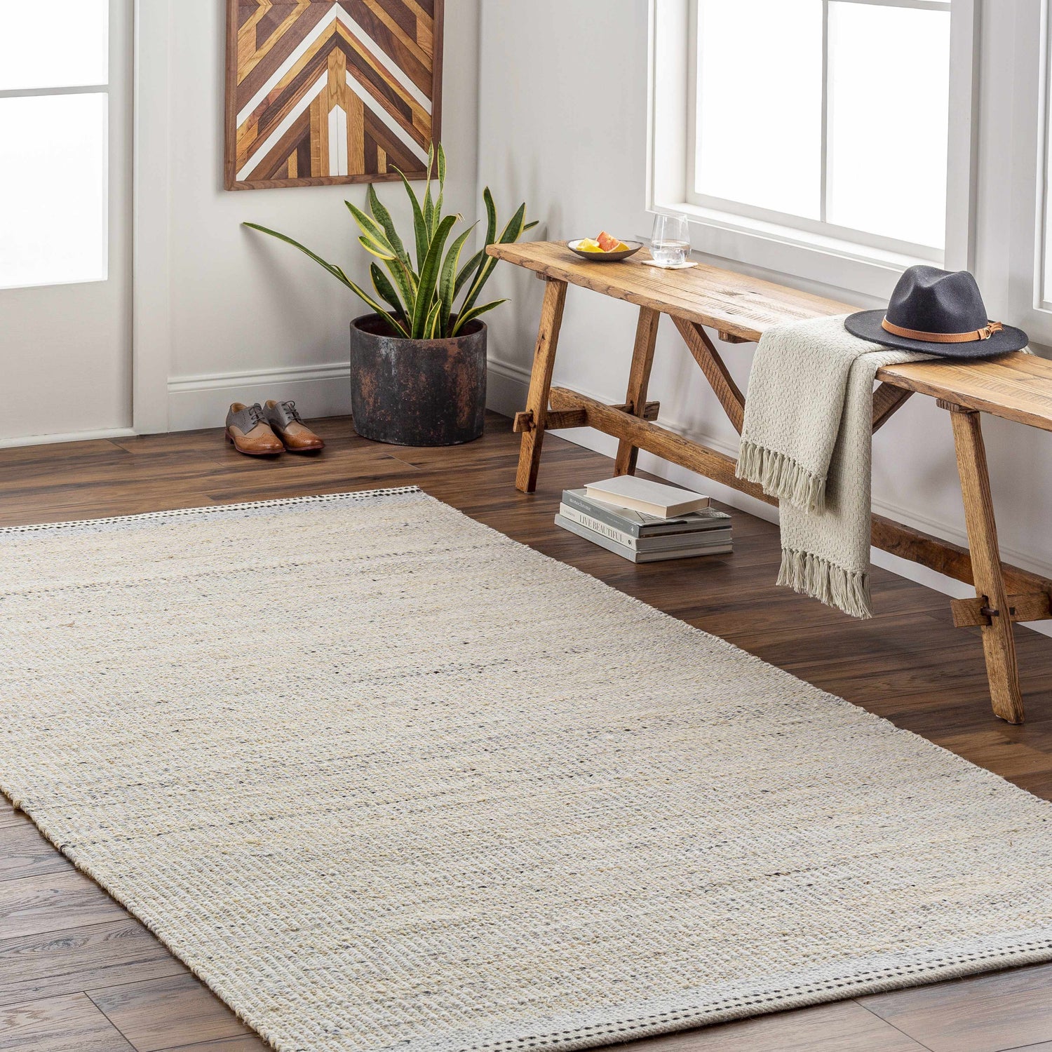 Entryway with Lumatil Area Rug in cream and beige. Farmhouse style with wood bench, plant, and wood art. Roomscene-Rectangle