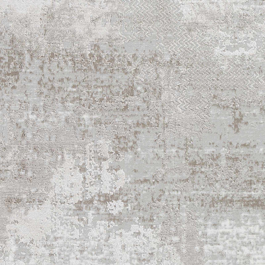 Close-up of the Lumbia Distressed Embossed Area Rug. Contemporary style rug with a textured pattern in shades of gray and beige. Swatch