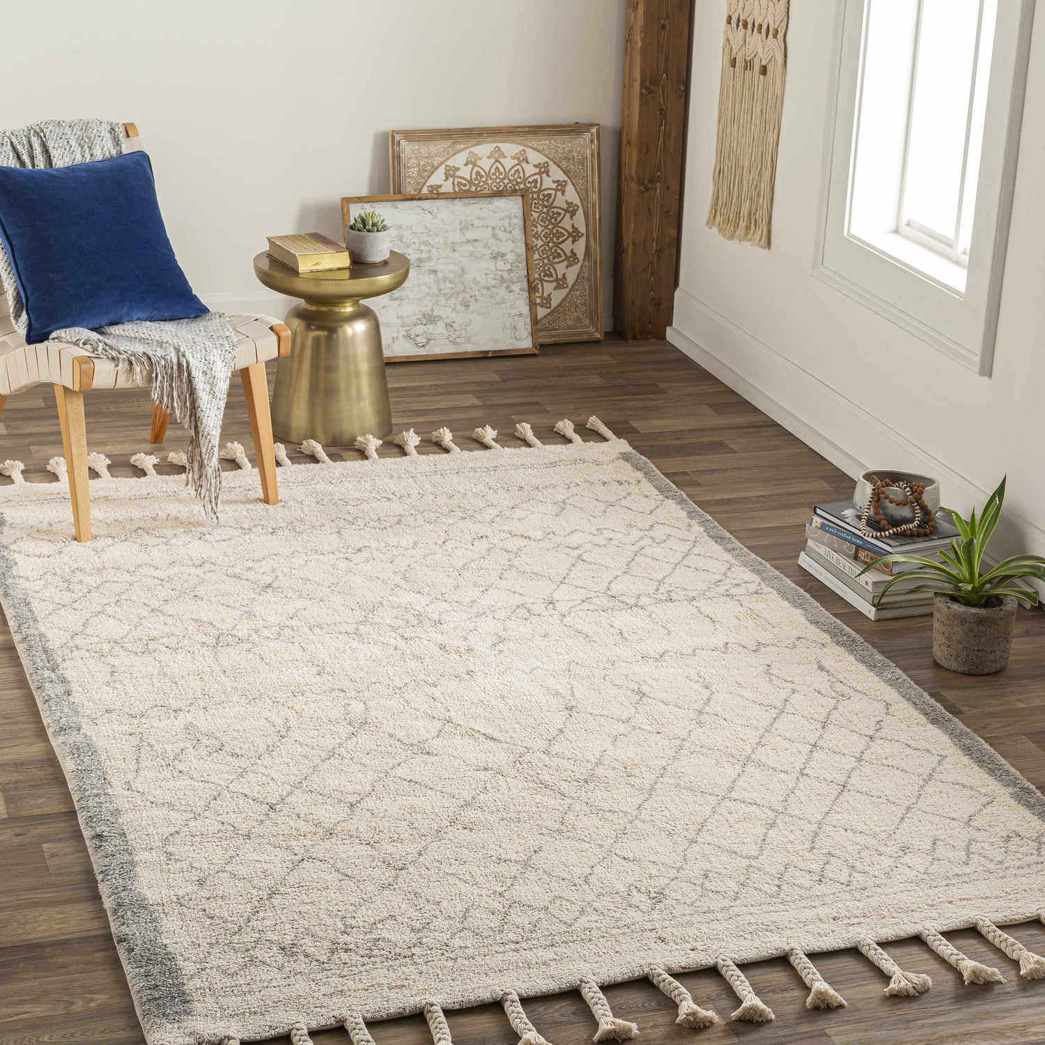 Styled room featuring the Luncarty Area Rug. Cream rug with gray geometric pattern and tassels in a neutral, farmhouse-style space. Roomscene-Rectangle