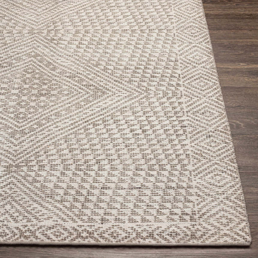 Close-up of the hand-knotted Lusacan Area Carpet. Charcoal, gray, and off-white geometric pattern. Viscose texture. Front