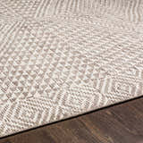 Close-up of the Lusacan Area Carpet. Hand-knotted rug with a geometric pattern in charcoal, gray, and off-white. Viscose material. Texture