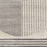 Close-up of the Elvi Area Rug featuring a geometric design with gray and natural gray stripes and textured details. Swatch