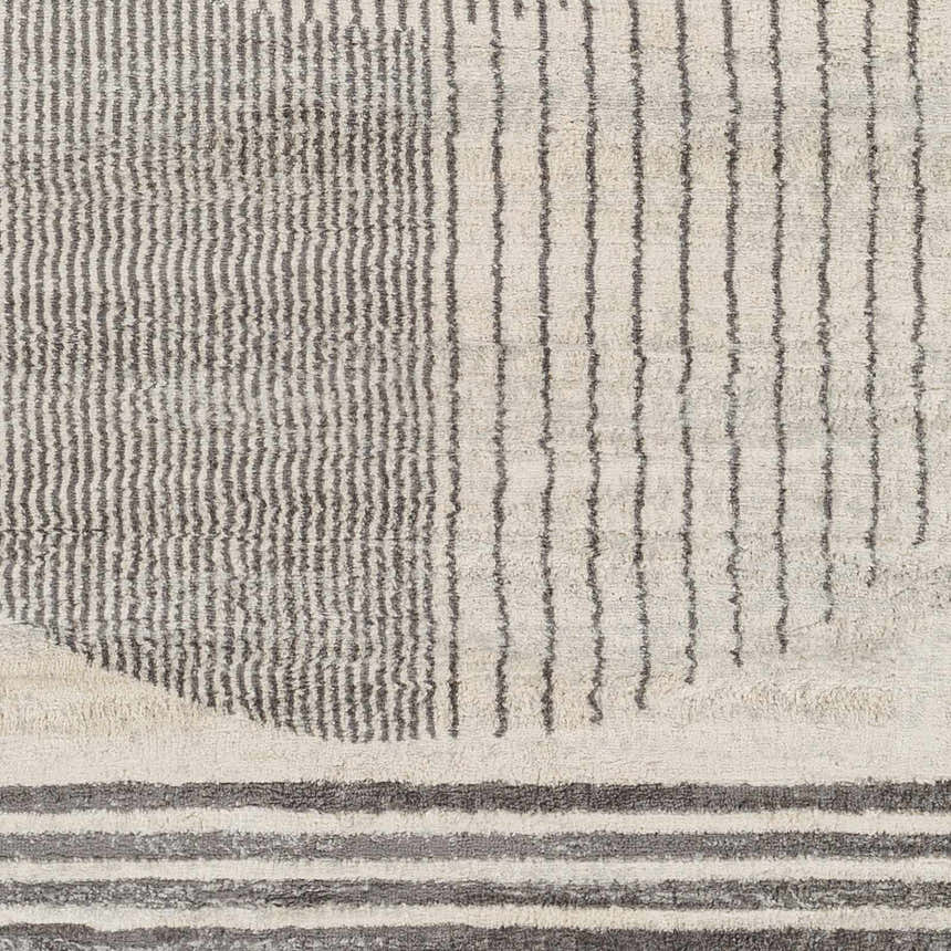 Close-up of the Elvi Area Rug featuring a geometric design with gray and natural gray stripes and textured details. Swatch