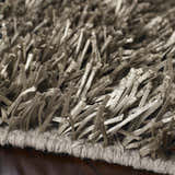 Close-up of the charcoal Morris Area Rug showing its hand woven texture and polyester shag fibers. Texture