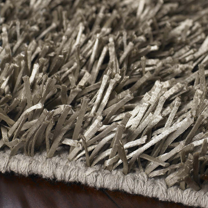 Close-up of the charcoal Morris Area Rug showing its hand woven texture and polyester shag fibers. Texture