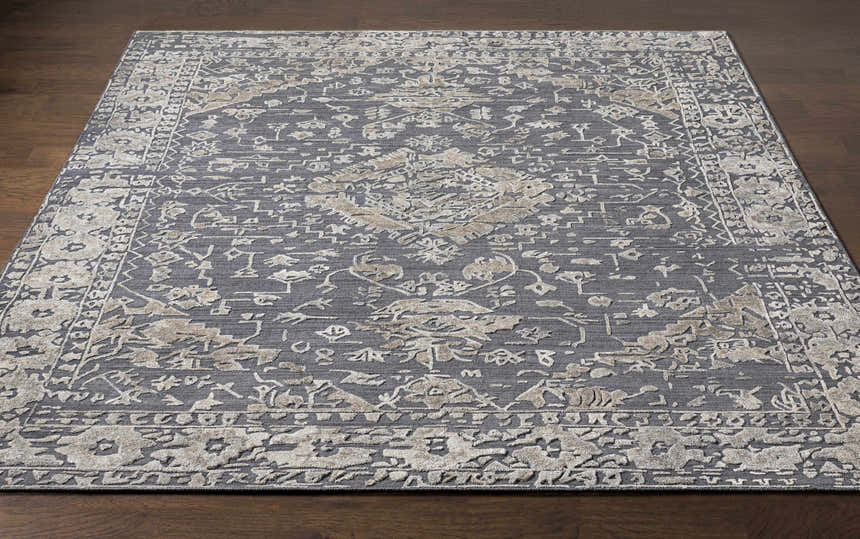 Close-up of the Macgregor Area Rug. Charcoal rug with light gray and light olive traditional bohemian pattern and hand loomed texture. Front