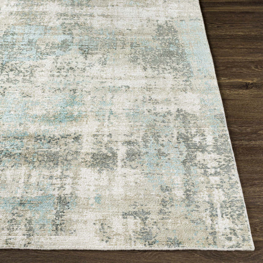 Close-up of the Machen Area Rug. Beige, ice blue, and gray contemporary design on a hand-knotted wool and viscose rug. Front
