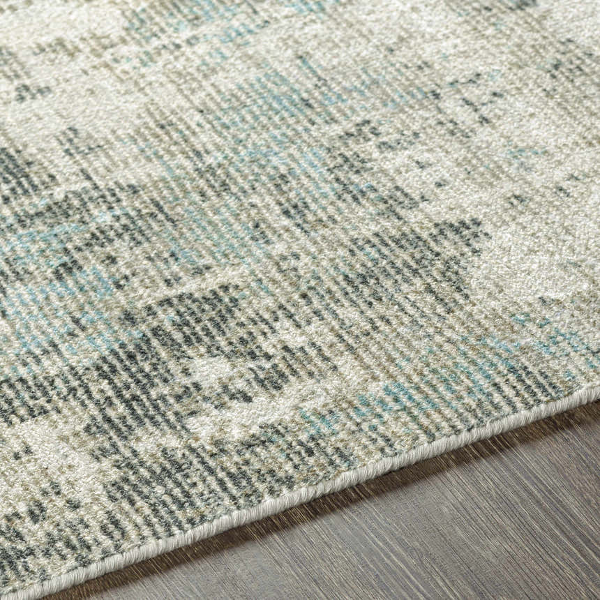 Close-up of the Machen Area Rug showing its beige, ice blue, and gray contemporary design and hand-knotted wool texture. Texture