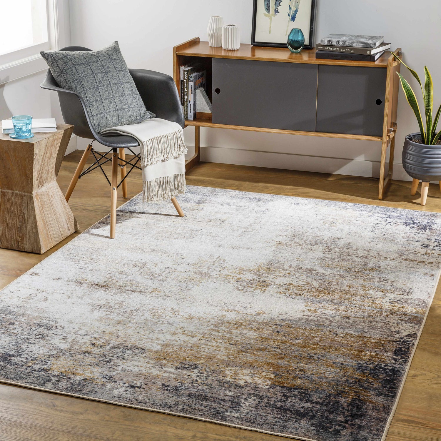 Living room scene with a Magbay Washable Area Rug. Contemporary rug with blue, brown, and gray tones complements the modern decor. Roomscene-Rectangle