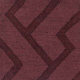 Close-up of the plum Magness Area Rug, a hand-loomed wool rug with a contemporary geometric pattern. Texture