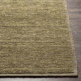 Close-up of the hand-loomed Magpet Area Rug. Olive green, light beige, and charcoal wool rug texture. Contemporary style. Front