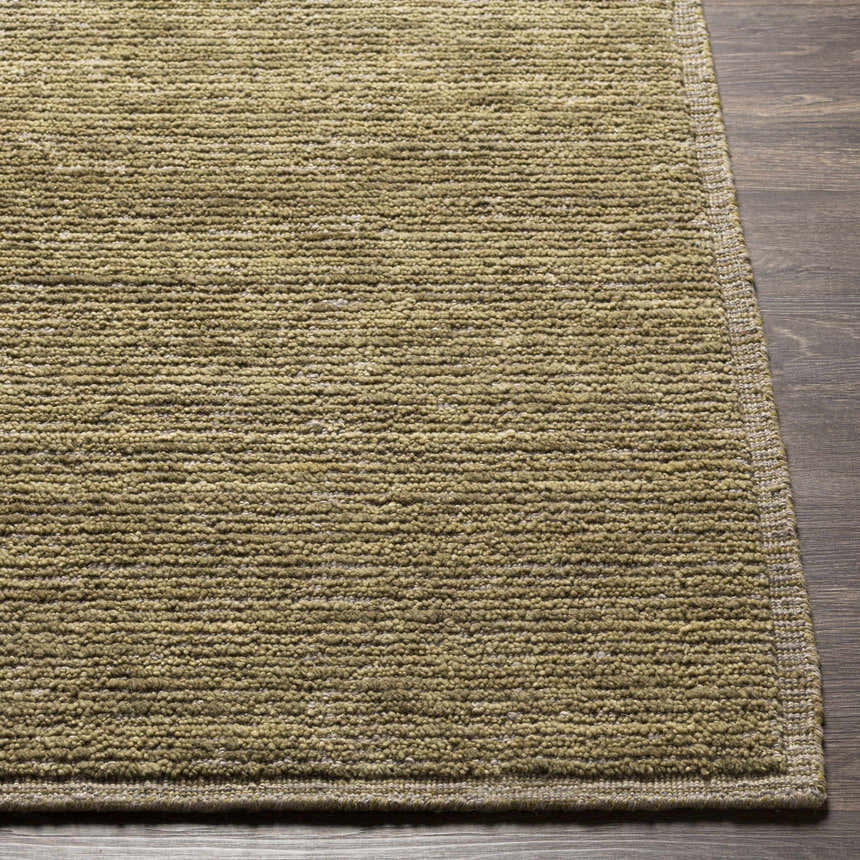 Close-up of the hand-loomed Magpet Area Rug. Olive green, light beige, and charcoal wool rug texture. Contemporary style. Front