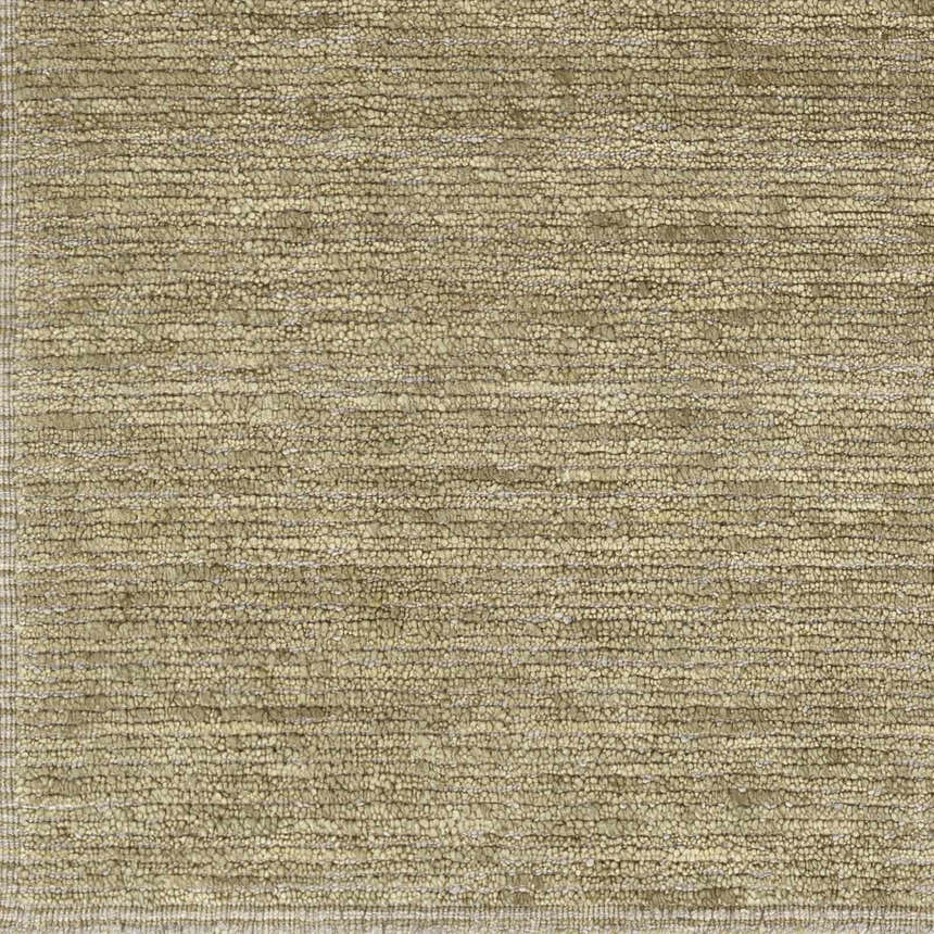 Close-up of the hand-loomed Magpet Area Rug. Olive, light beige, and charcoal wool create a textured, contemporary design. Swatch