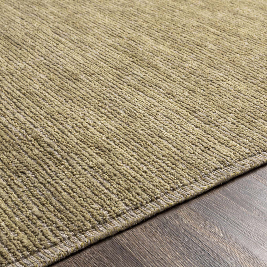 Close-up of the hand-loomed Magpet Area Rug. Olive green wool rug with a subtle textured, contemporary design. Texture