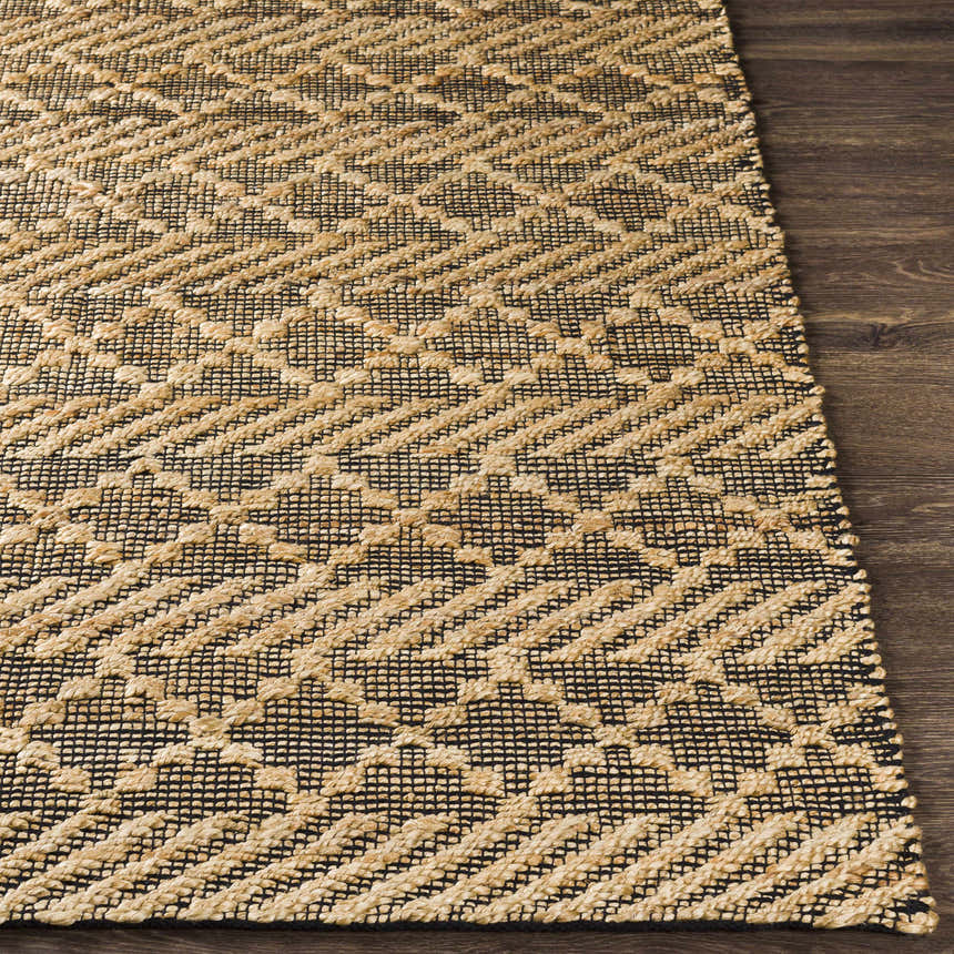 Close-up of the hand woven Malidong Jute Carpet. Black and tan geometric pattern on a jute rug. Farmhouse style. Front