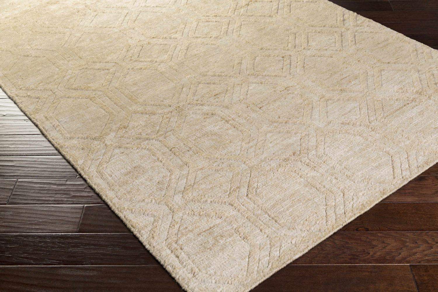 Close-up of the beige Manchester Clearance Jute Rug showing its geometric pattern and natural fiber texture on dark wood floors. Corner