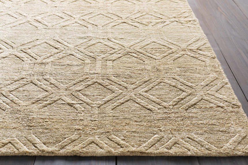 Close-up of the beige Manchester Clearance Jute Rug, featuring a raised diamond pattern and natural fiber texture. Styleshot