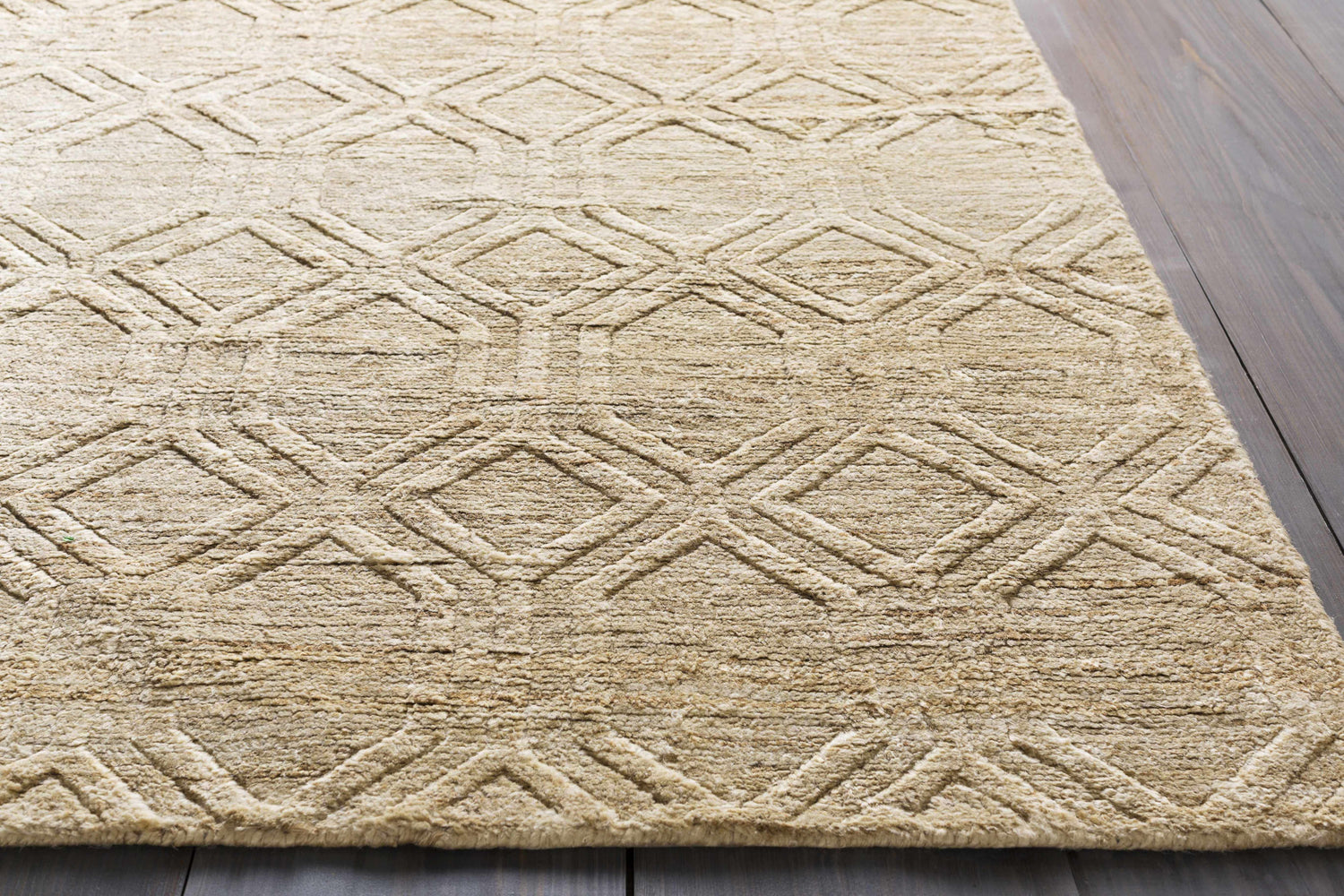 Close-up of the beige Manchester Clearance Jute Rug, featuring a raised diamond pattern and natural fiber texture. Styleshot