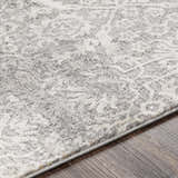Close-up of the textured Mandurah Area Rug - Clearance. Cream and gray traditional pattern on a machine-woven rug. Texture
