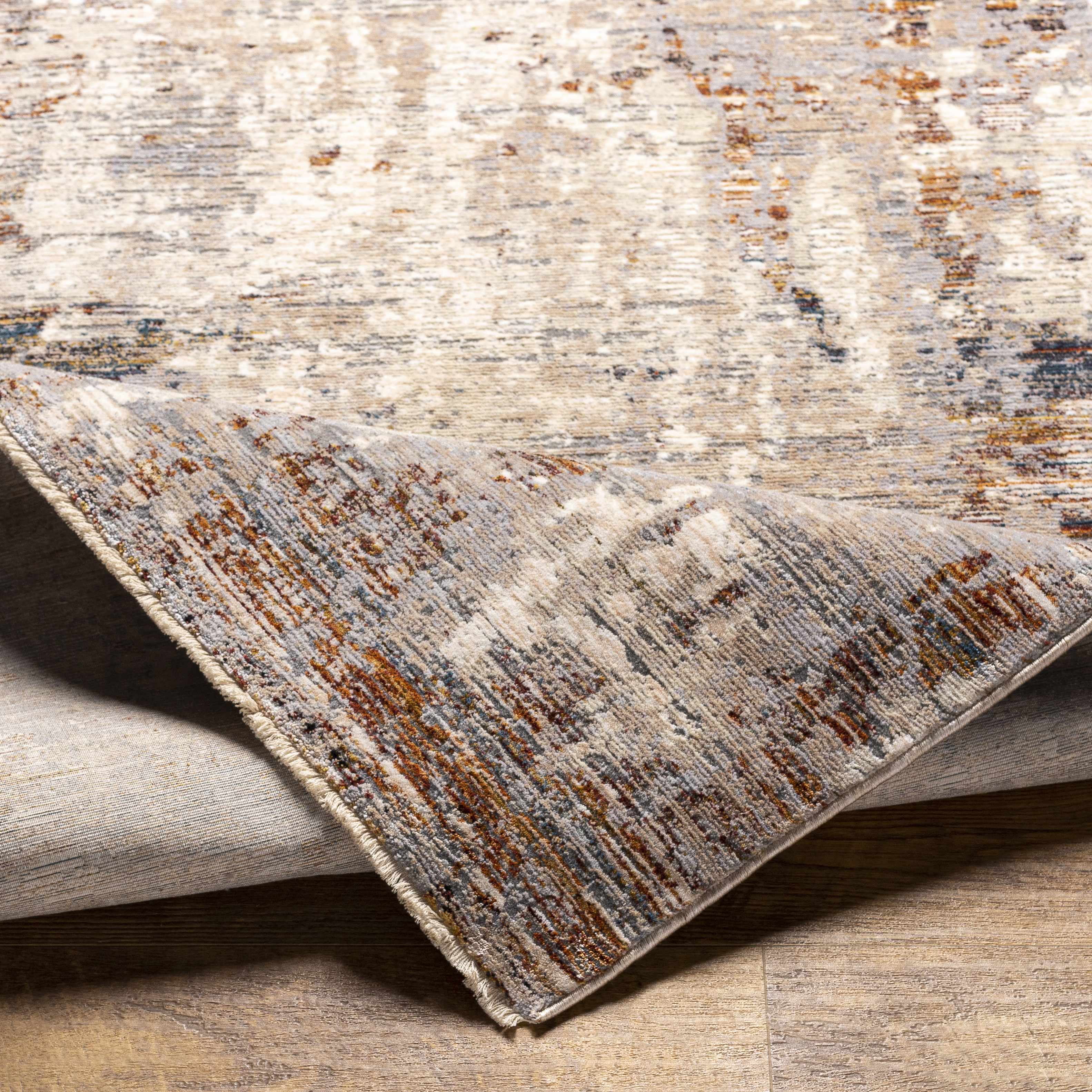 Folded section of Mangili Area Rug - Clearance, displaying material thickness and weave. Traditional Area Rug Backing  