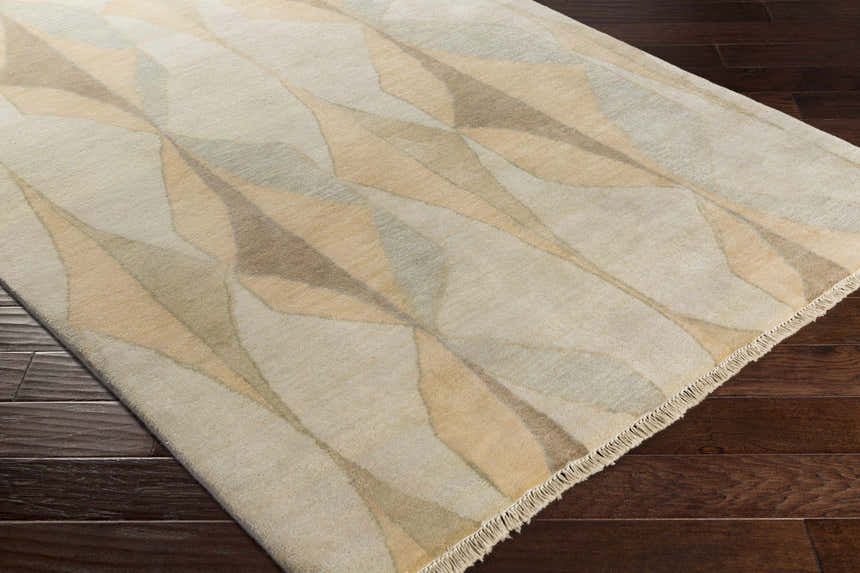 Close-up of the hand-knotted Marblemount Carpet. Contemporary wool rug with brown, tan, sage, and olive geometric pattern. Corner