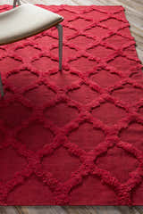 Close-up of the red Marilla Area Rug, a hand-woven wool shag with a geometric trellis pattern. Styleshot