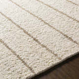 Close-up of the hand woven Matawan Premium Wool Rug in ivory with taupe stripes, showcasing its texture. Texture