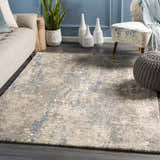 Living room scene with a blue accent wall and the Matewan Thick Luxe Rug in blue, denim, and ivory. Roomscene-Rectangle