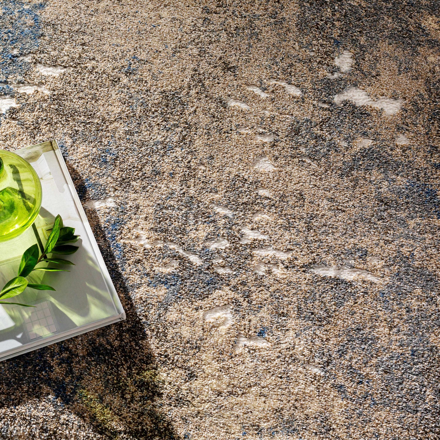 Close-up of the Matewan Thick Luxe Rug. Abstract pattern in blue, denim, ivory, and white. Soft, textured feel. Styleshot