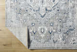 Close-up of the Mateo Area Rug, a light gray traditional rug with silver and pale slate accents. Fold