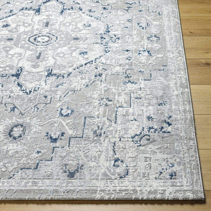 Close-up of the Mateo Area Rug, a light gray traditional rug with a pale slate and silver pattern on wood flooring. Front